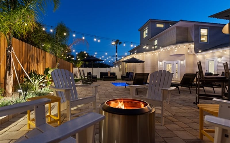 Tropical themed back yard with pool, fire ring, putting green, tiki hut and much more