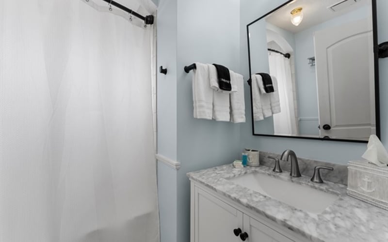 Upstairs hallway bathroom modern shower & tub combo with vanity
